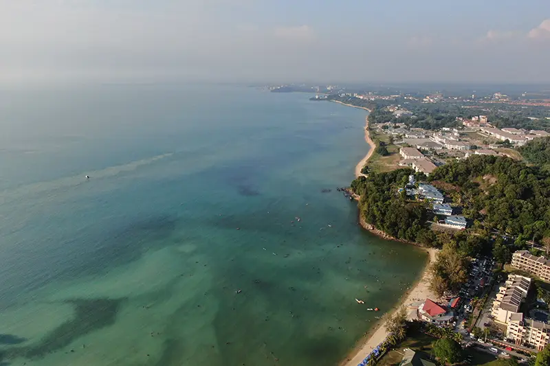 Aerial view of Port Dickson coastline with clear waters and beachfront hotels