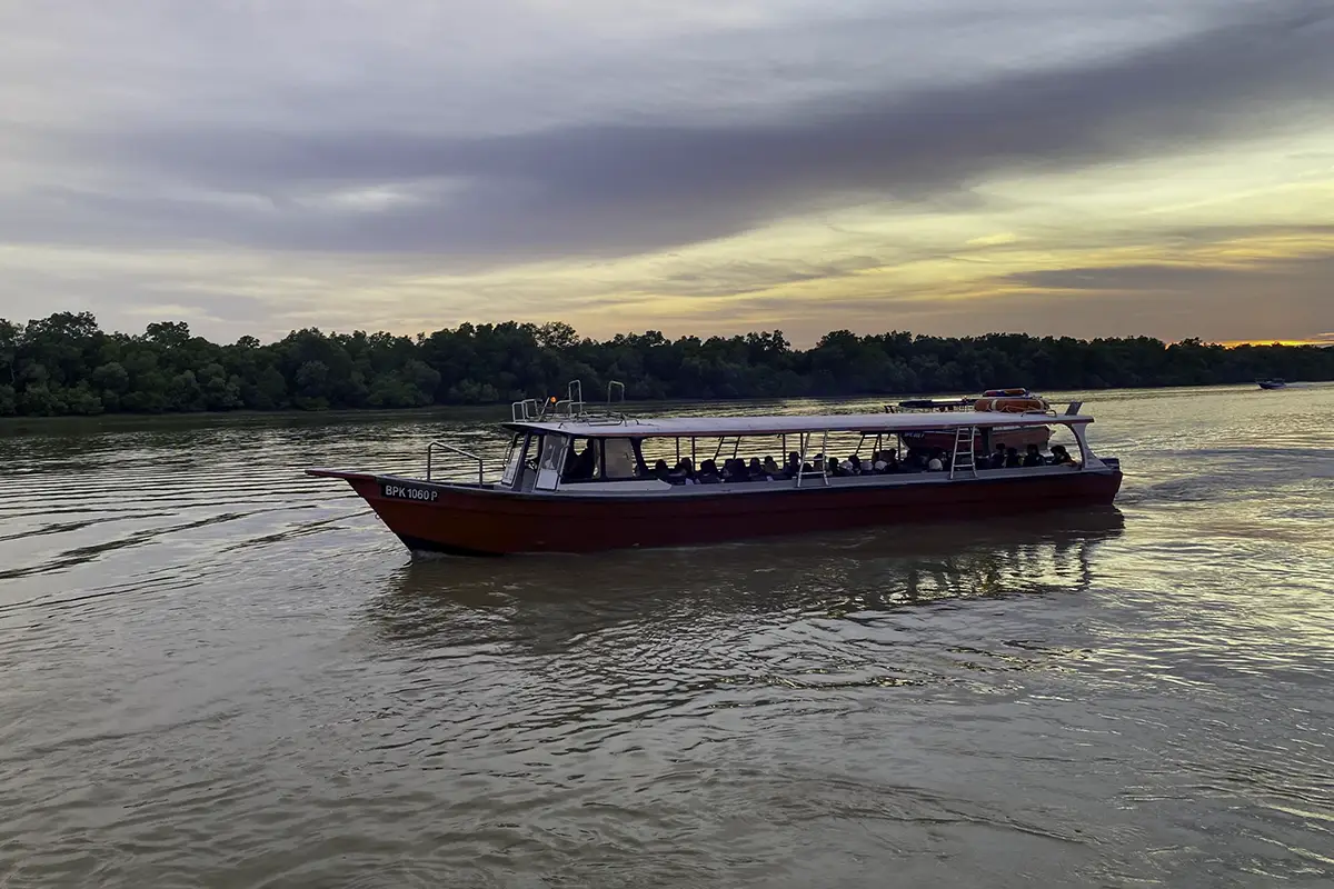 Motorized boat with tourists on a fireflies tour at Pasir Penambang Fireflies Jetty in Kuala Selangor