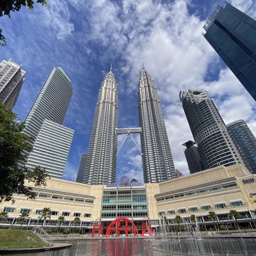 Petronas Twin Towers – Featured Stop on Kuala Lumpur City and Batu Caves Tour Petronas Twin Towers viewed from KLCC Park, a top stop on a Kuala Lumpur city tour and often included in combination Batu Caves tours