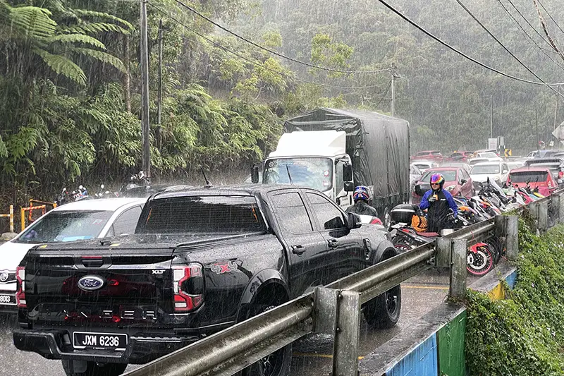 Traffic congestion and heavy rain on a winding road in Cameron Highlands