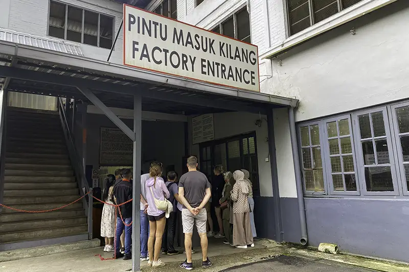 Visitors queue at the factory entrance for a guided tour at BOH Tea Centre Sungei Palas in Cameron Highlands