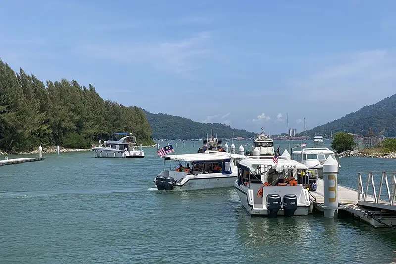 Boats at Pangkor Laut jetty in Marina Island, Lumut – accessible via KLIA private transfer