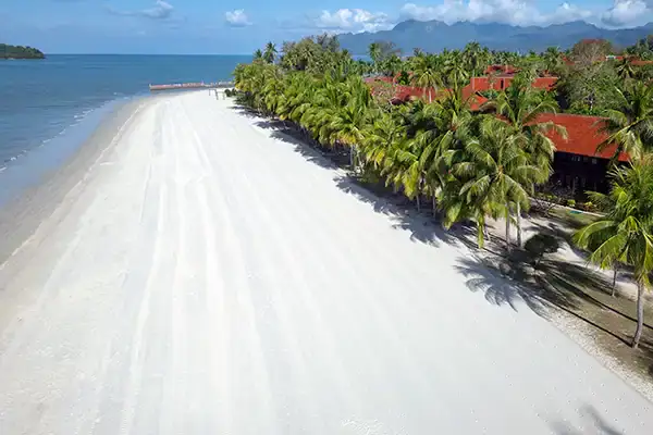 Aerial view of the wide sandy shoreline at Cenang Beach in Langkawi