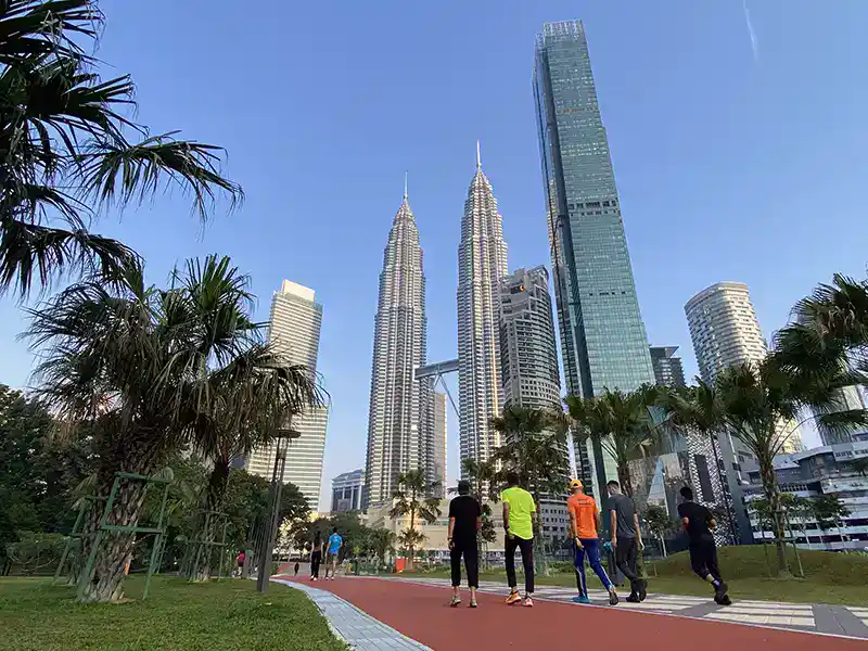 KLCC Park jogging track with Petronas Twin Towers in the background, one of the top Kuala Lumpur destinations