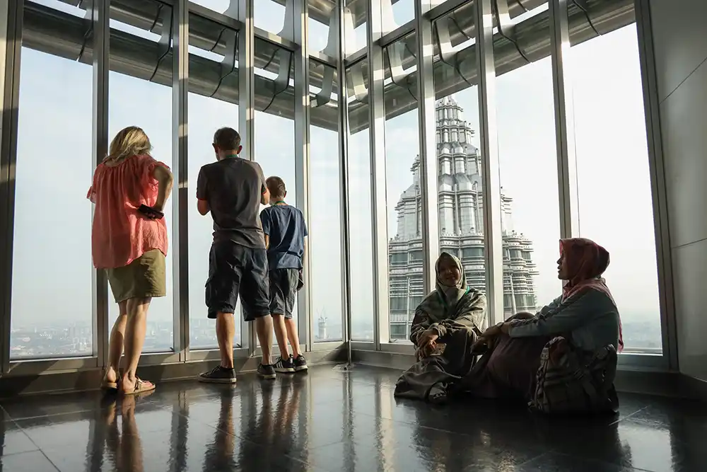 Visitors enjoying the view from the observation deck at the Petronas Twin Towers in Kuala Lumpur