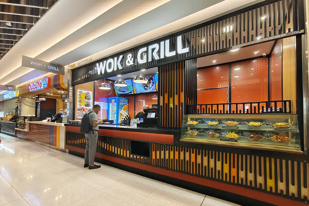 Food stalls at the Suria KLCC food court in Kuala Lumpur offering local and international dishes