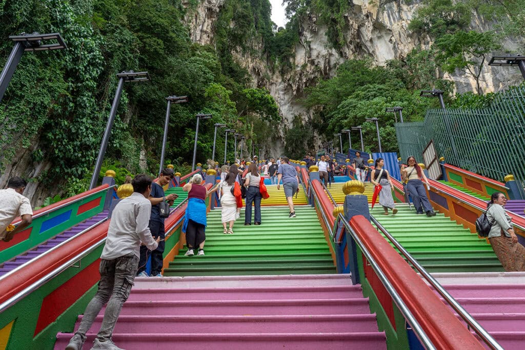 Visitors climbing the colourful 272-step staircase at Batu Caves leading to the Temple Cave in Kuala Lumpur