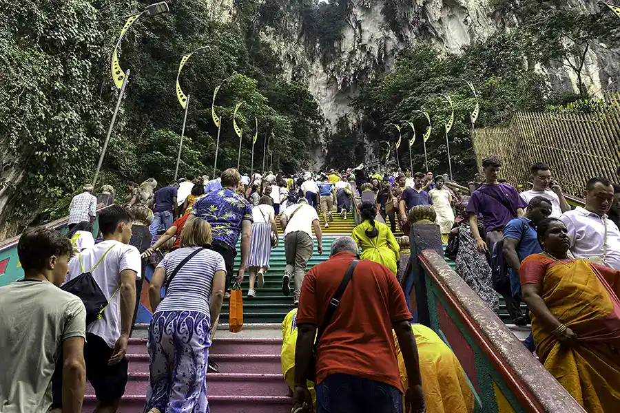 Crowds climbing the Batu Caves rainbow staircase during a busy weekend