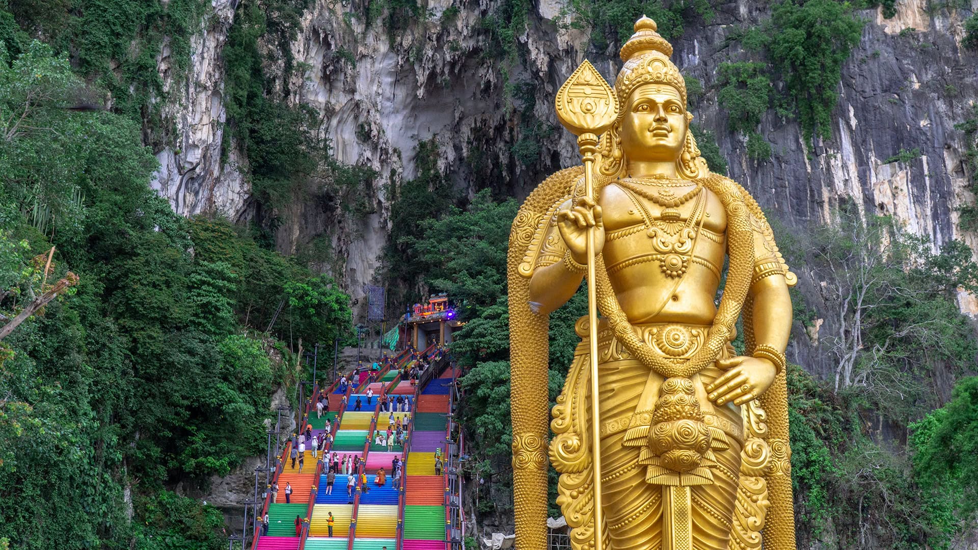 Lord Murugan statue and rainbow staircase leading to the Temple Cave at Batu Caves near Kuala Lumpur