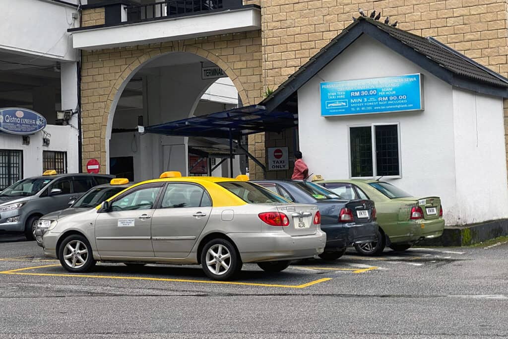 Taxis waiting for passengers at Tanah Rata bus terminal in Cameron Highlands