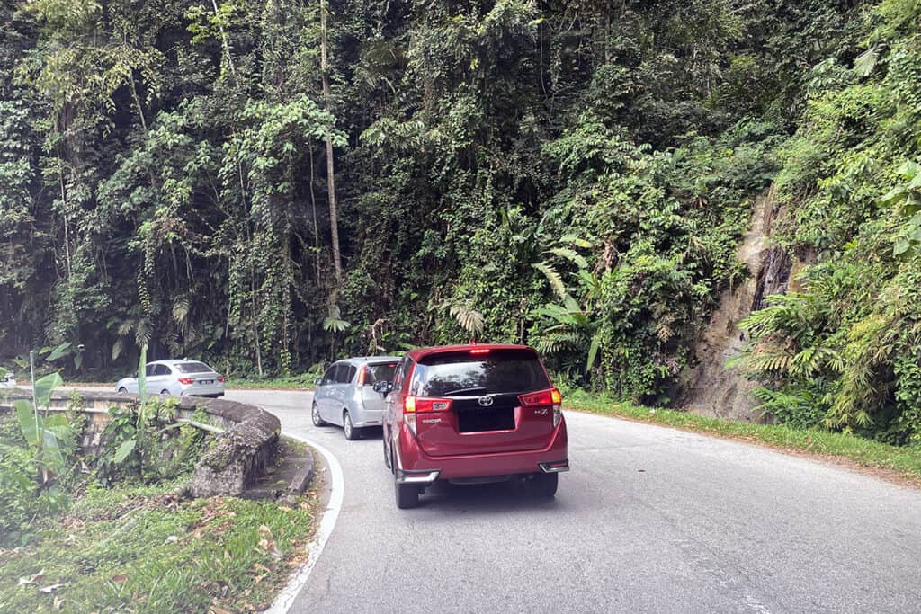 Winding mountain road to Cameron Highlands in Malaysia showing driving conditions for self-drive travel