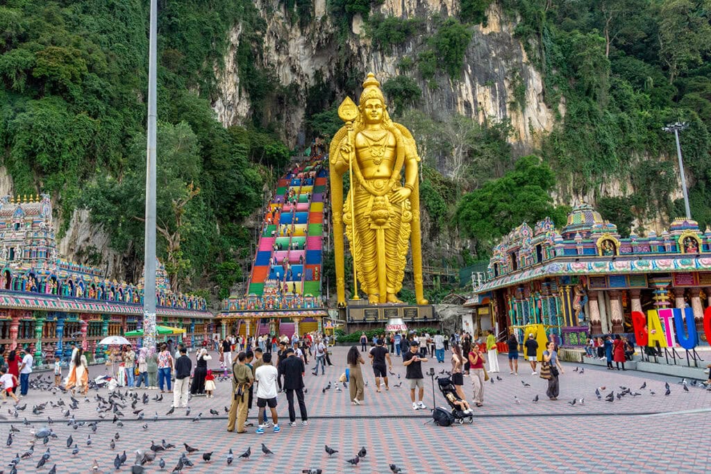 Lord Murugan statue at the entrance of Batu Caves in Kuala Lumpur with the colourful 272-step staircase leading to the Temple Cave
