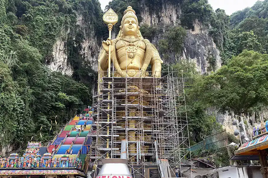 Lord Murugan statue at Batu Caves during repainting process in November 2025