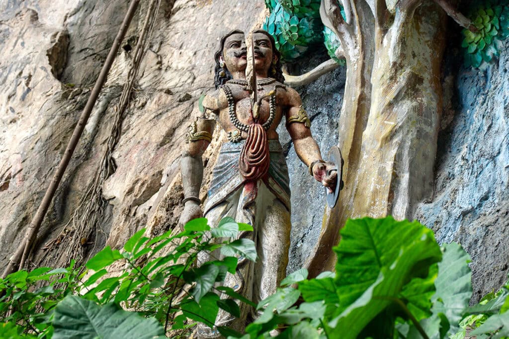 Statue of Lord Murugan defeating the demon Surapadman inside Batu Caves temple in Kuala Lumpur