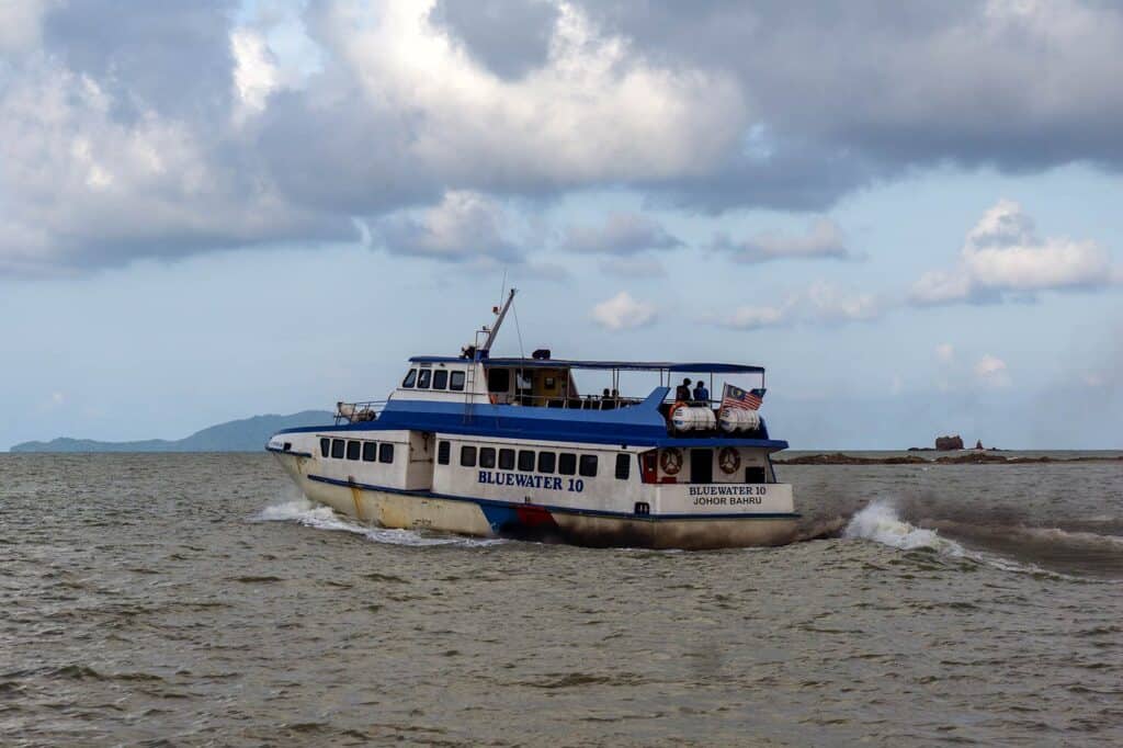Bluewater 10 ferry crossing from Mersing Jetty to Tioman Island with passengers on the open top deck — ferry service operated by Bluewater Express