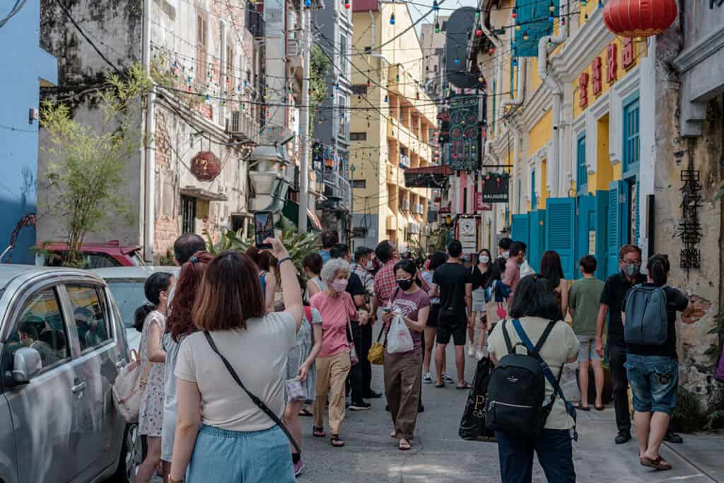 Kwai Chai Hong alley in Chinatown Kuala Lumpur — 
restored heritage lane with coloured string lights 
and crowds of visitors