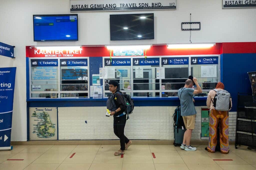 Local islander and foreign tourists at Bluewater Express check-in counter in Mersing Harbour Centre — local islanders and international visitors share the same ferry service to Tioman Island