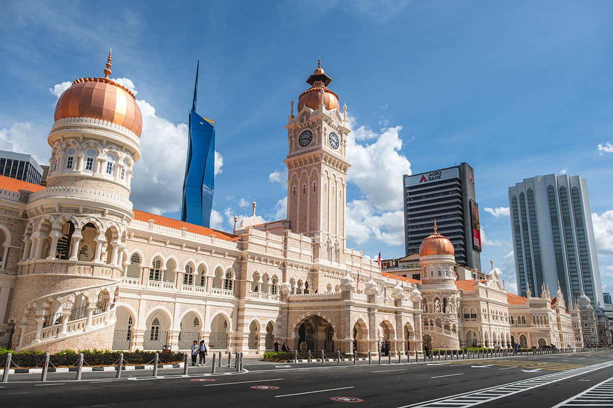 Sultan Abdul Samad Building with Moorish copper domes and clock tower facing Merdeka Square — the most recognisable colonial landmark in Kuala Lumpur built in 1897