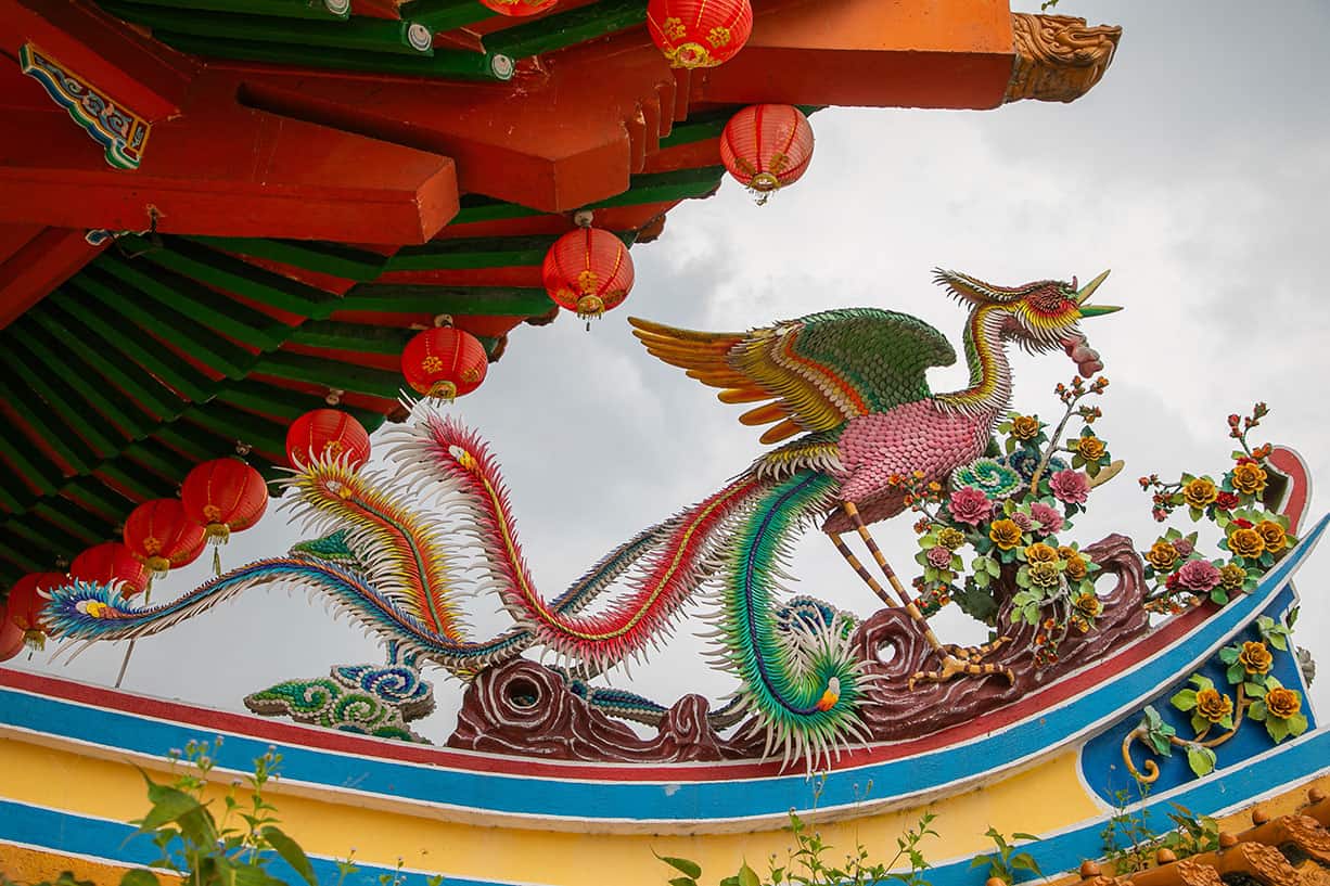 Colourful phoenix sculpture and red lanterns decorating the rooftop of Thean Hou Temple — a Taoist Buddhist temple dedicated to Mazu in Kuala Lumpur