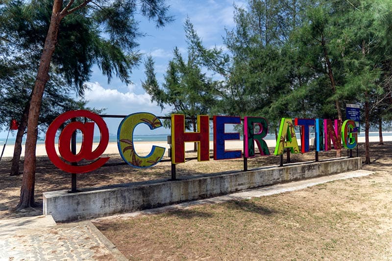 Colourful @Cherating landmark sign on the beachfront with casuarina trees and South China Sea in the background — Cherating, Pahang