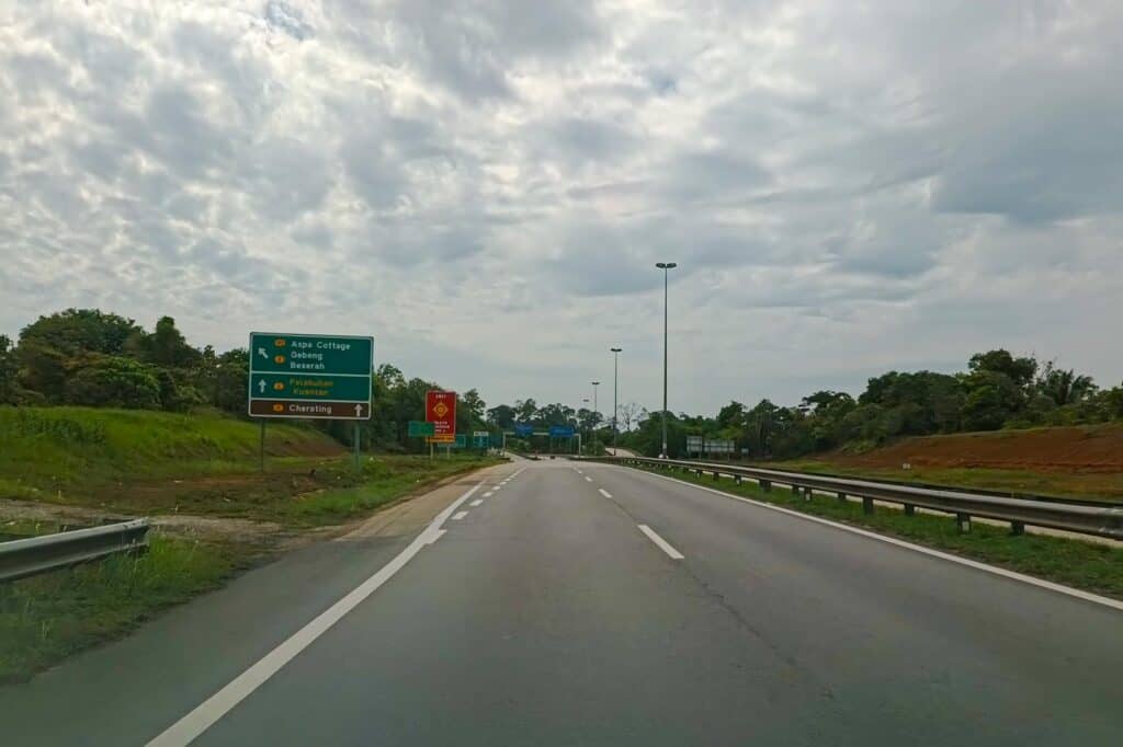 Highway signboard on the East Coast Expressway showing the exit toward Cherating, Pahang — self-drive route from Kuala Lumpur to Cherating