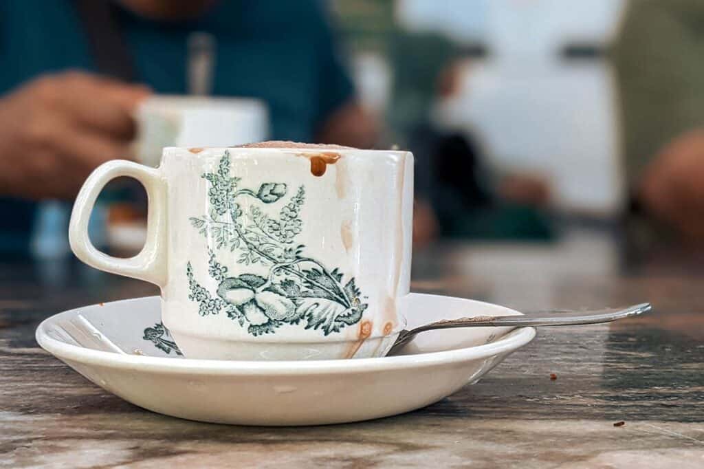 Ipoh white coffee served in traditional floral porcelain cup at an Old Town kopitiam Malaysia