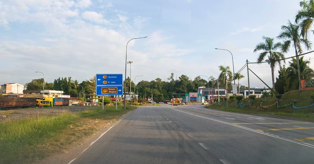 Road sign at Jerantut junction showing directions to Taman Negara National Park, Pahang, Malaysia