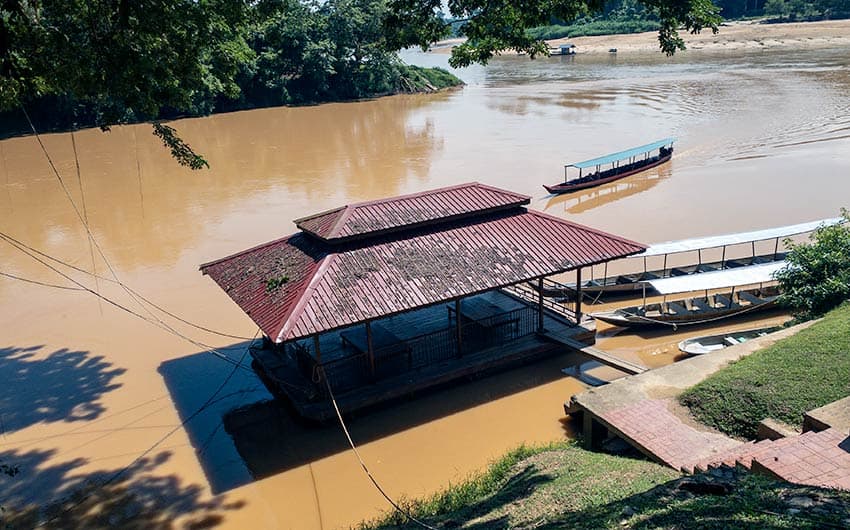 Longboat arriving at Kuala Tembeling jetty on the Tembeling River — the traditional river route from Kuala Lumpur to Taman Negara National Park