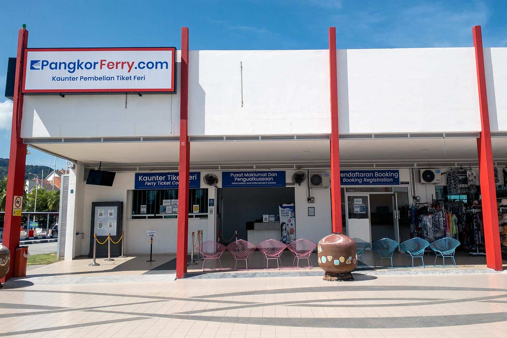 Marina Island Jetty showing PangkorFerry.com ticket counter, information centre, and Booking Registration counter side by side — the three counters passengers need for the Pangkor Island ferry