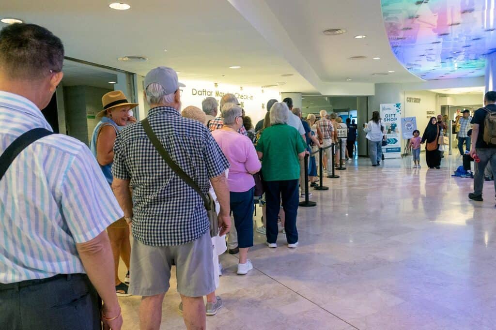 Long queue of tourists at the Petronas Twin Towers Sky Xperience check-in area inside the lobby