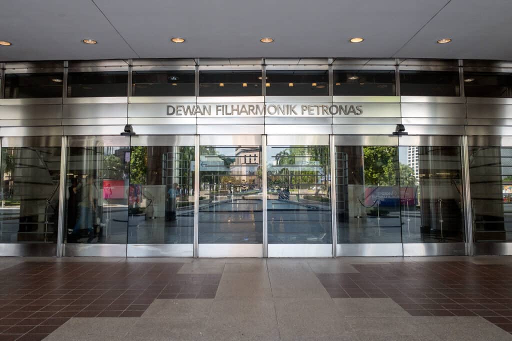 Dewan Filharmonik Petronas main entrance facing KLCC Park — entry point to Petronas Twin Towers Sky Xperience