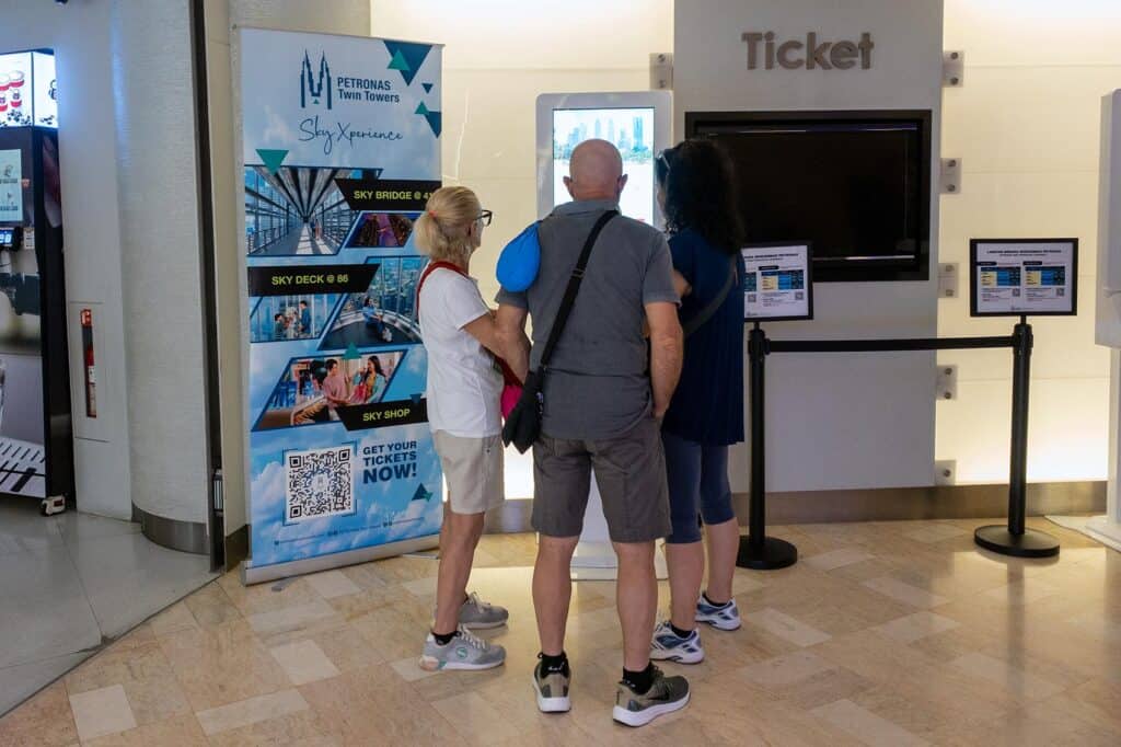 Tourists at the Petronas Twin Towers Sky Xperience walk-in ticket counter inside the towers lobby