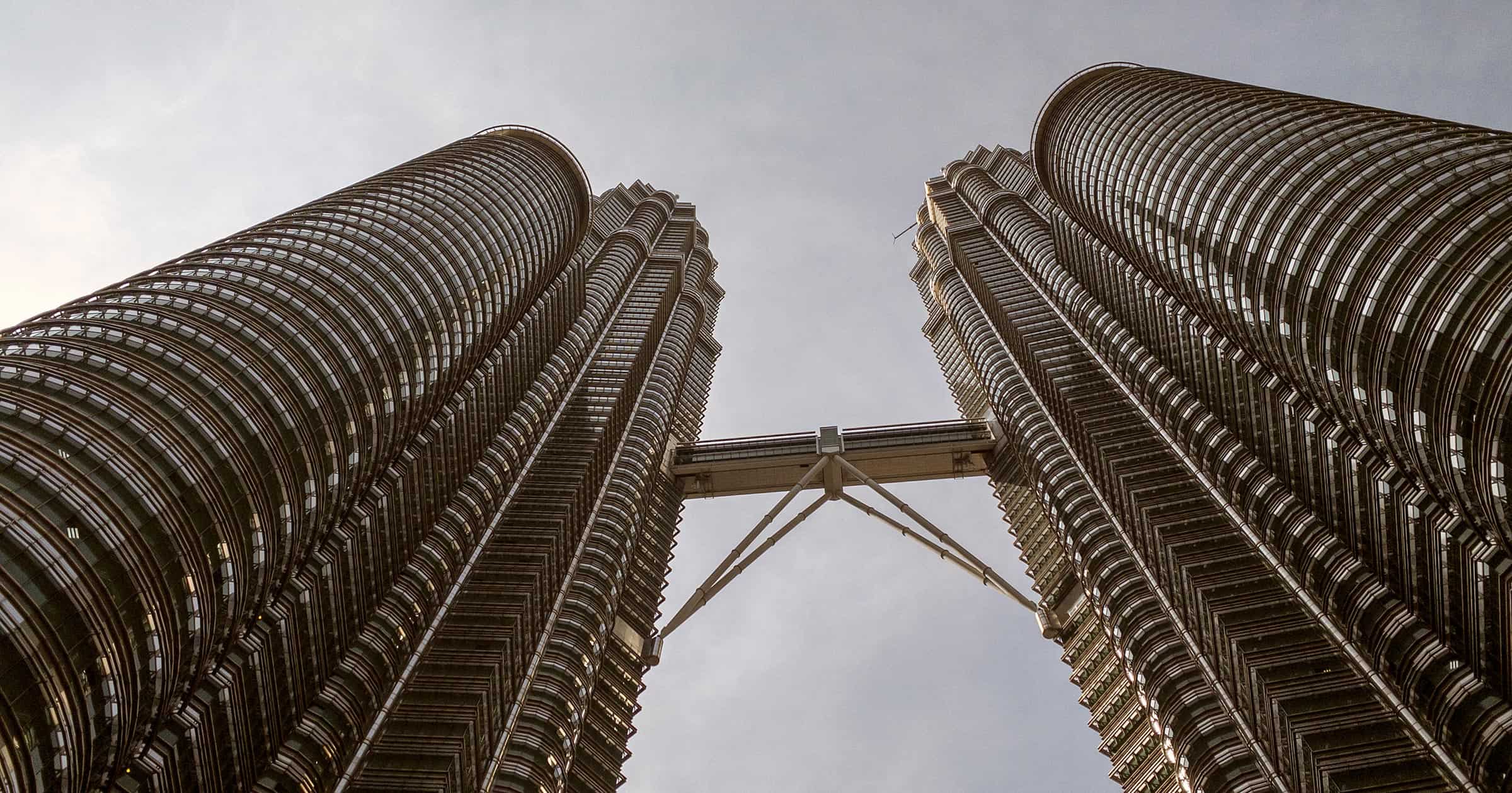 Looking up at the Petronas Twin Towers Sky Bridge from directly below showing both towers and the connecting bridge at Level 41