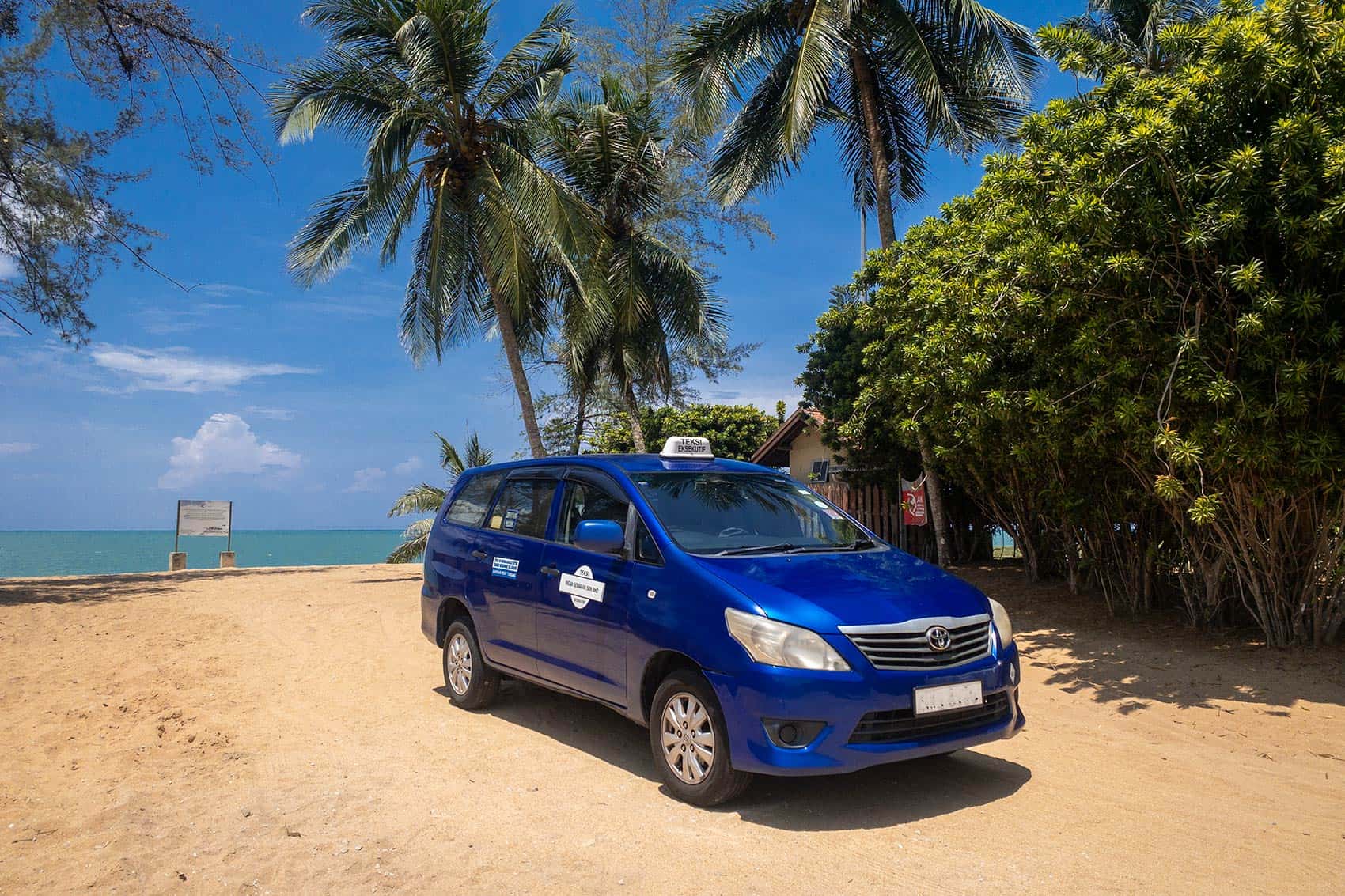 Toyota Innova MPV private transfer vehicle parked at Cherating beach, Pahang — door-to-door private transfer from Kuala Lumpur to Cherating