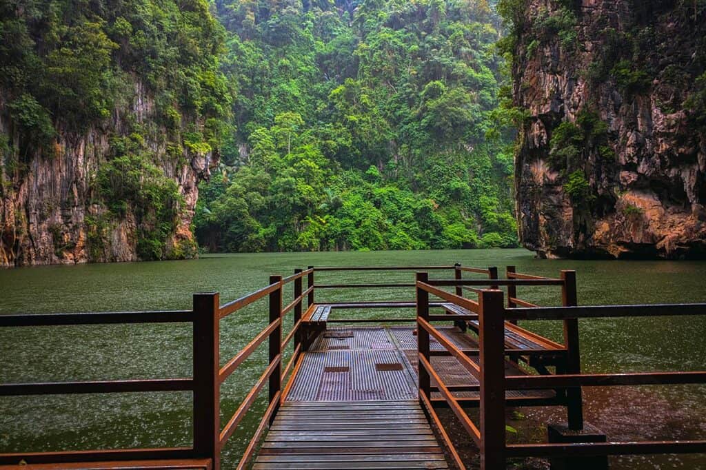 Tasik Cermin Mirror Lake hidden lagoon surrounded by limestone cliffs and jungle in Ipoh Malaysia