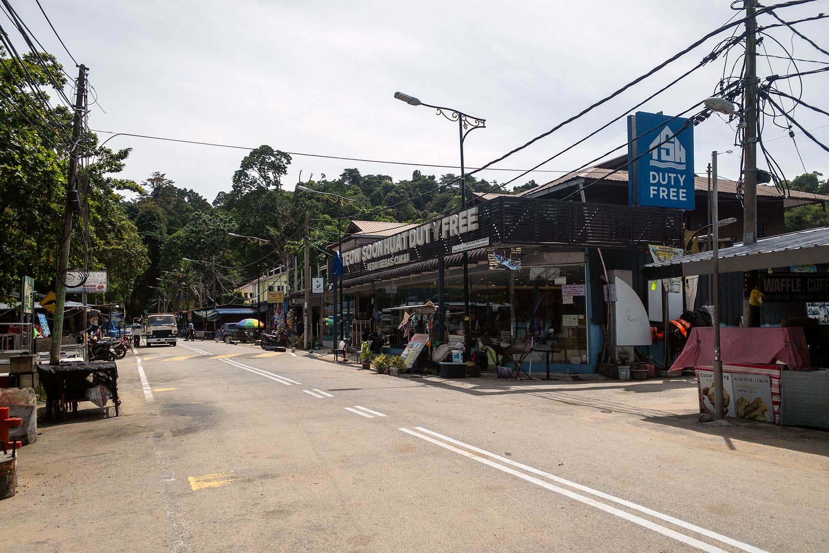 Row of restaurants and duty-free shops along the main road in Teluk Nipah, Pangkor Island.