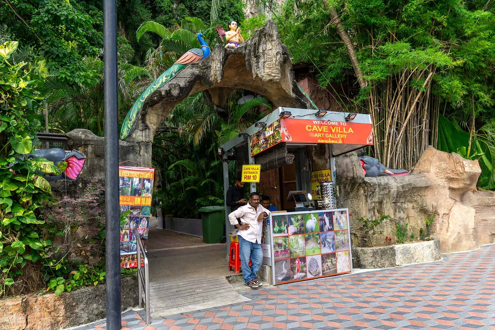 Cave Villa Art Gallery entrance showing Batu Caves ticket price RM 10 — entry fee for Hindu art exhibits and cave spaces
